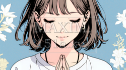 手を合わせてお祈りをしている若い女性