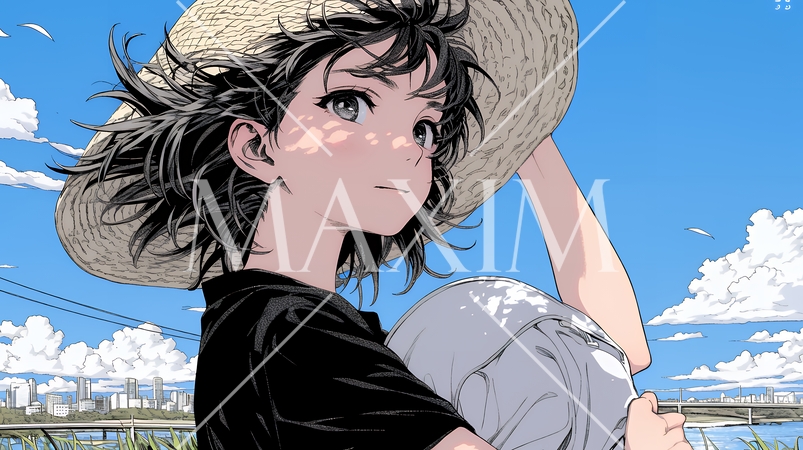 春風に飛ばされそうな帽子を、手で押さえる若い女性